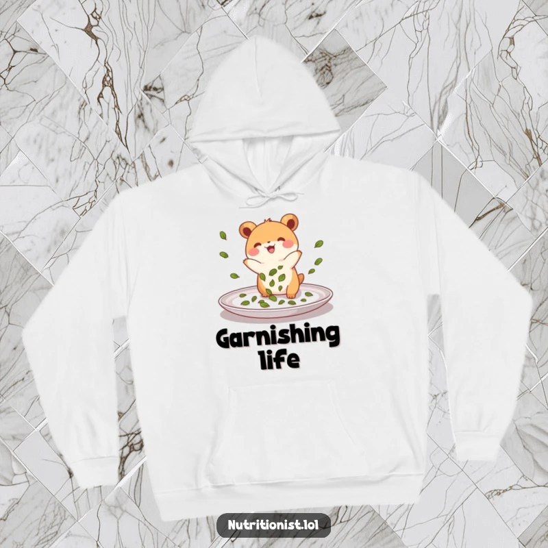 Funny hoodie featuring a small, energetic creature joyfully sprinkling green leaves onto a plate, designed for comfort and showcasing a passion for food.